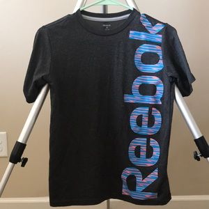 a grey reebok shirt with blue and orange letters